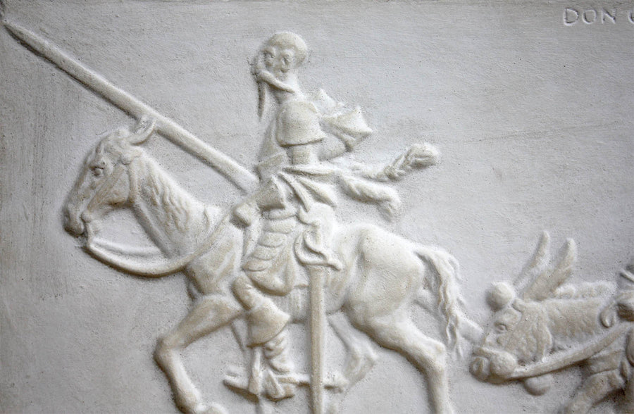 closeup photo of plaster cast relief sculpture of man riding horse in profile