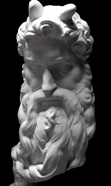 photo of plaster cast bust of man, namely Moses, with curly hair and so-called horns and long beard on black background