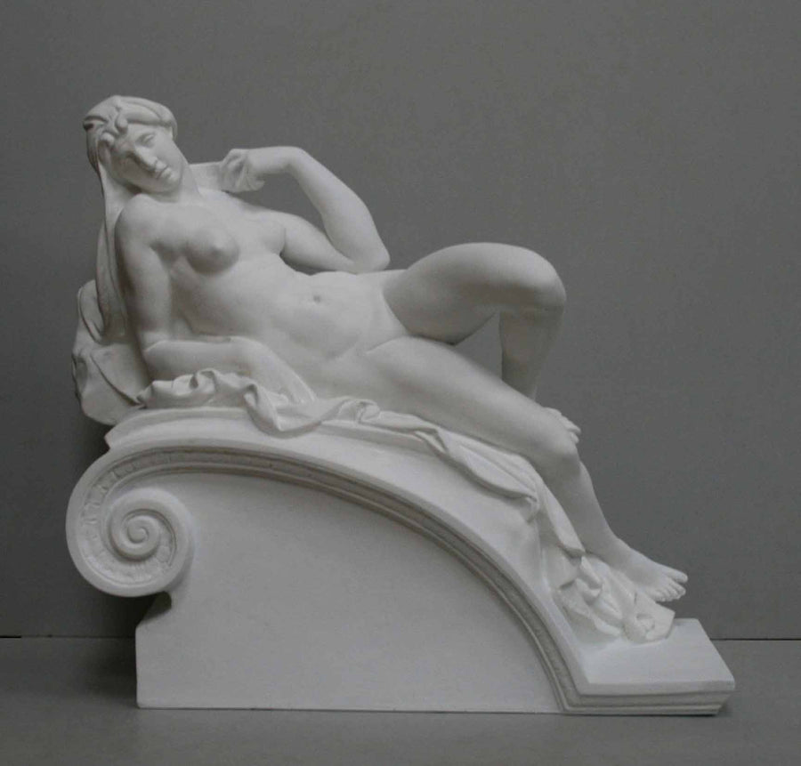 photo of plaster cast of reclining female nude with a gray background