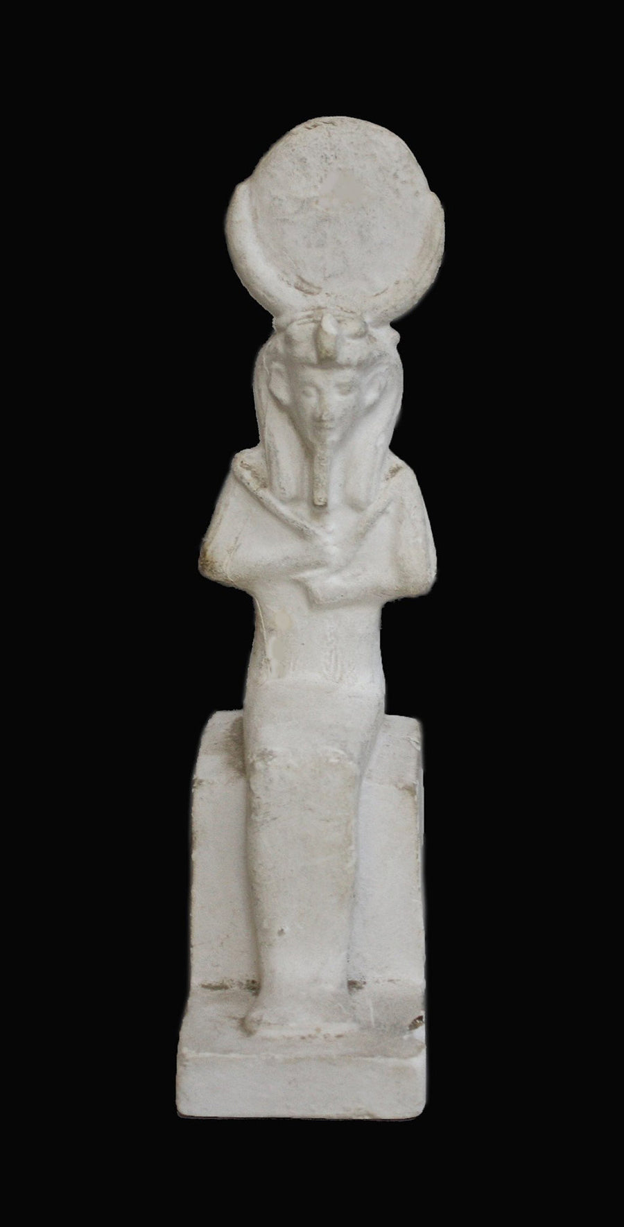 photo with black background of plaster cast sculpture of Egyptian mummy seated
