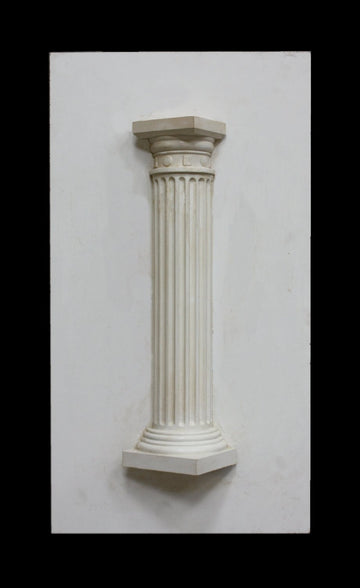 photo of plaster cast sculpture of Greek half column on a white panel