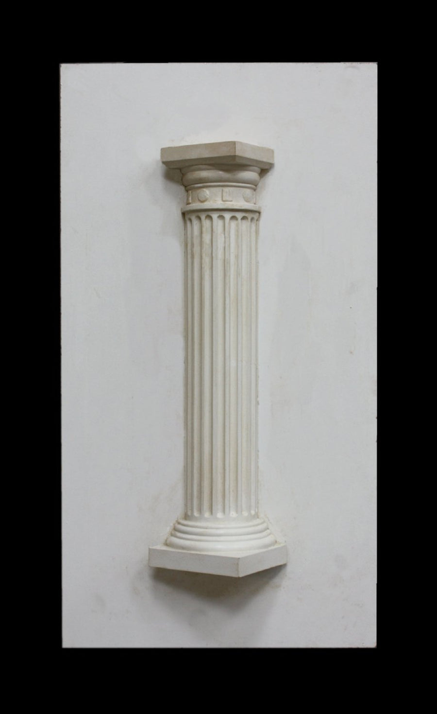 photo of plaster cast sculpture of Greek half column on a white panel