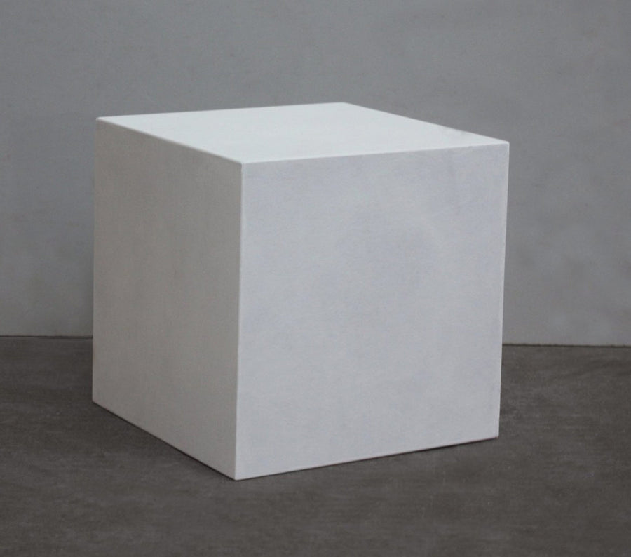 photo with gray background of plaster cast cube geometric shape