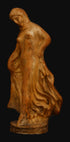 photo with black background of terracotta female dancer in flowing drapery