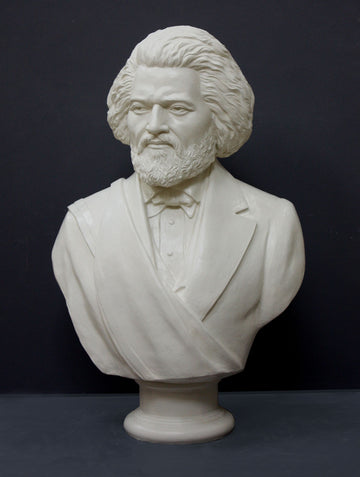 photo of white plaster cast sculpture of bust of Frederick Douglass with beard and in suit coat with toga over one shoulder on dark gray background