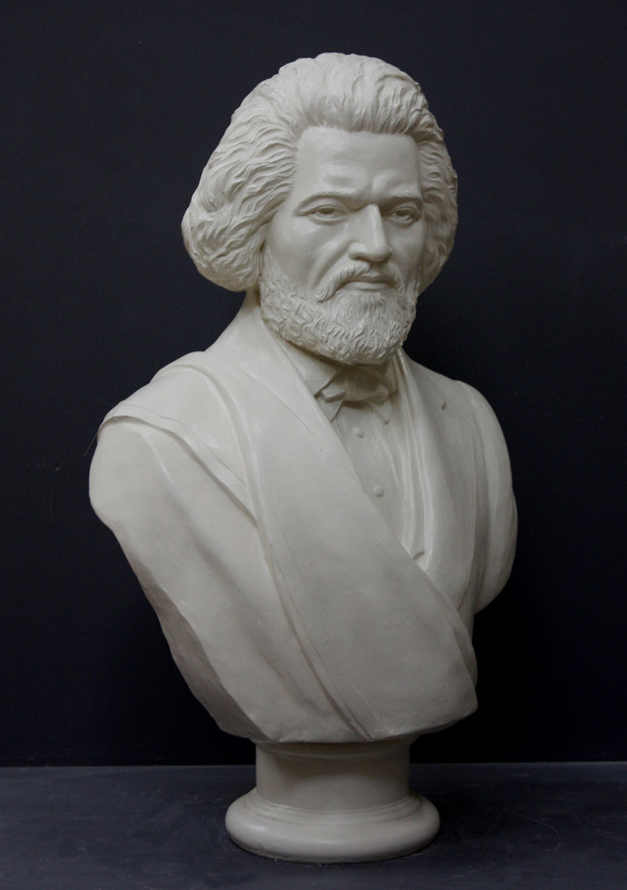 photo of white plaster cast sculpture of bust of Frederick Douglass with beard and in suit coat with toga over one shoulder on dark gray background