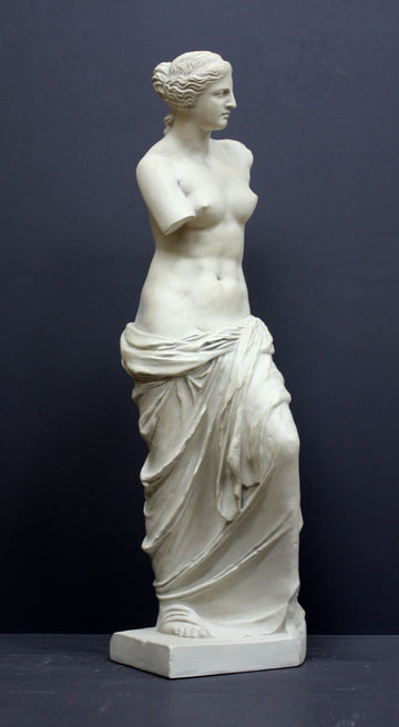 Photo of plaster cast sculpture reproduction of Venus de Melo on a grey background