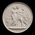 photo of off-white plaster cast relief sculpture of male and female figures walking through field of wheat and a female figure kneeling in the field cutting wheat against black background