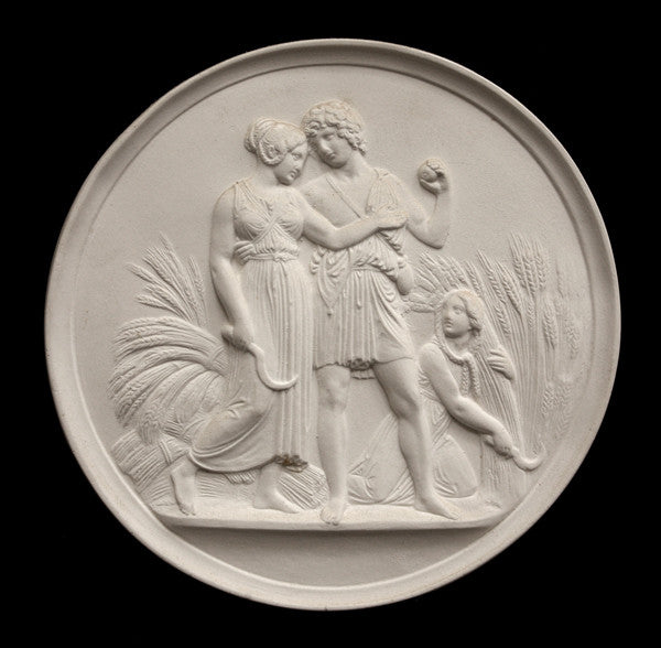 photo of off-white plaster cast relief sculpture of male and female figures walking through field of wheat and a female figure kneeling in the field cutting wheat against black background