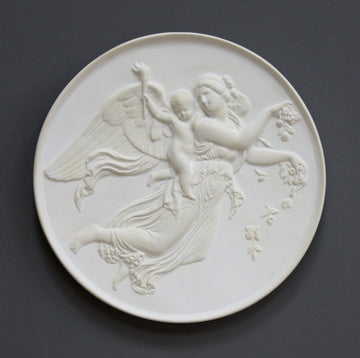 photo with gray background of plaster cast relief of female with wings flying and a cherub on her back