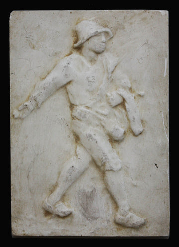 photo of plaster cast relief of man walking with a black background