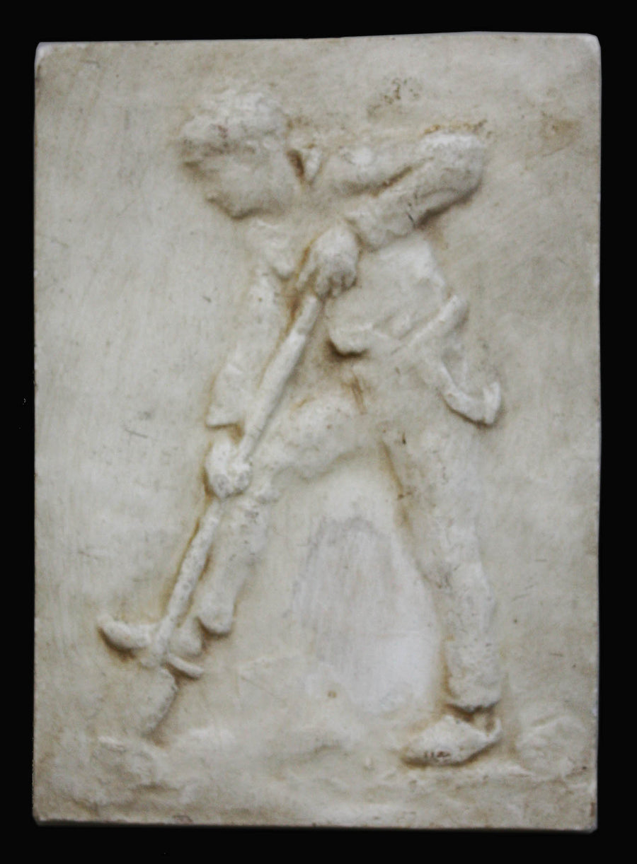 photo of plaster cast relief of man digging with a black background