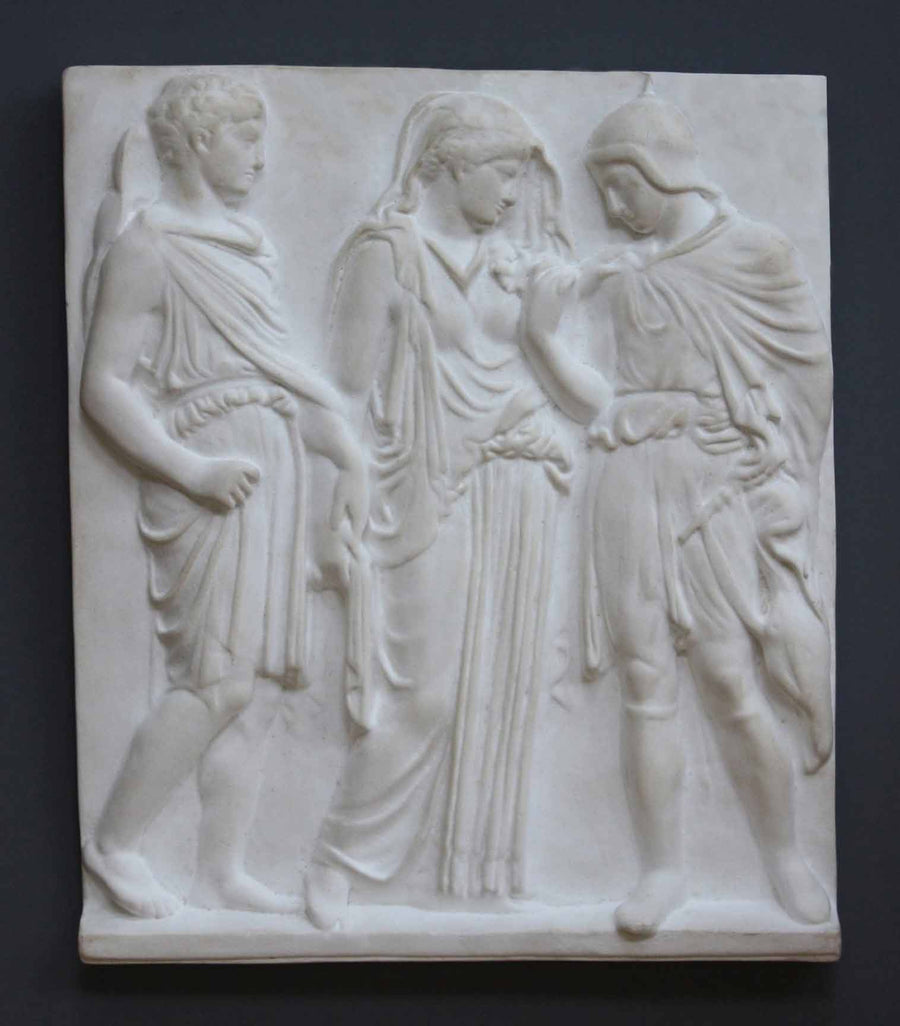 photo with gray background of plaster cast of ancient relief with three figures, namely Hades, Eurydice, and Orpheus