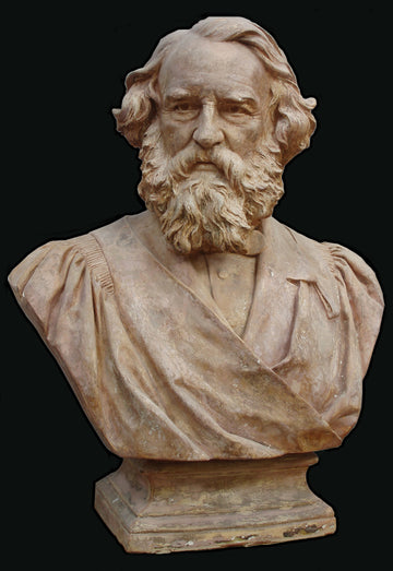 photo with black background of aged plaster cast of man's bust, namely Longfellow, with long hair and curly beard and ceremonial robes