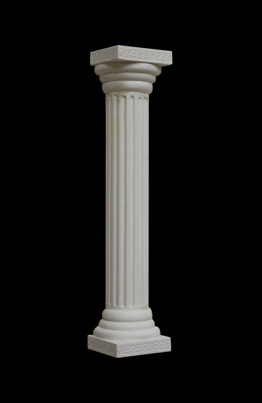 photo with black background of plaster cast sculpture of Greek half round column