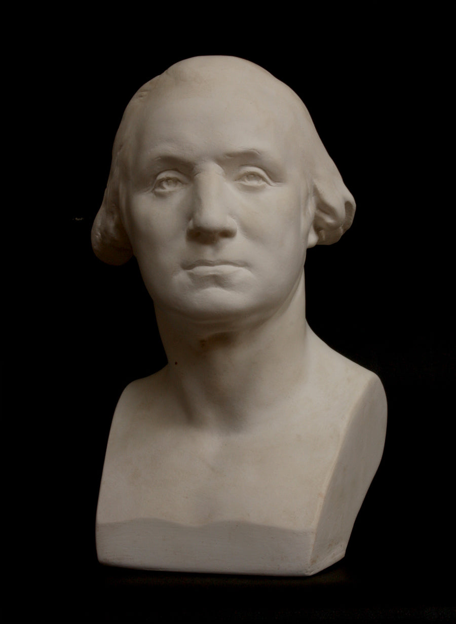 Photo of plaster cast of male bust on black background