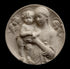 photo of plaster cast sculpture relief of the Madonna holding baby Jesus and angels in the background on a black background