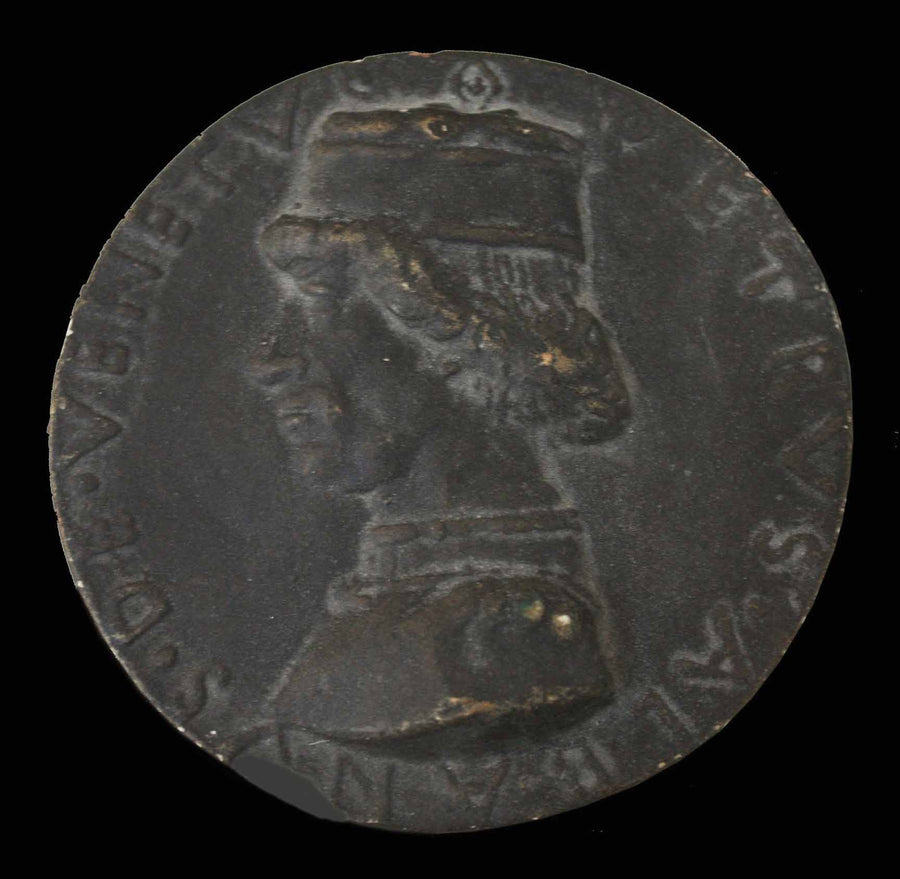 photo of plaster cast of small medallion with male portrait profile on black background