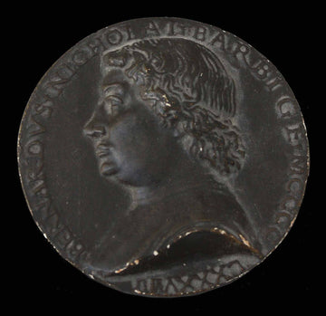 photo of plaster cast of small medallion with male portrait profile on black background