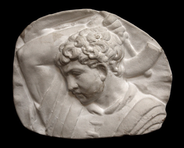 photo of plaster cast sculpture relief of upper body of male with arm raised behind head and holding a hammer with a black background