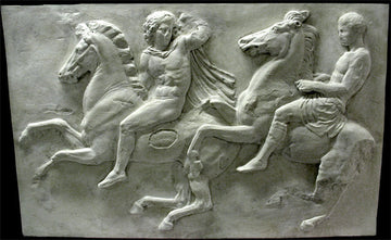 photo of off-white plaster cast relief sculpture of two men on horseback from Parthenon against black background