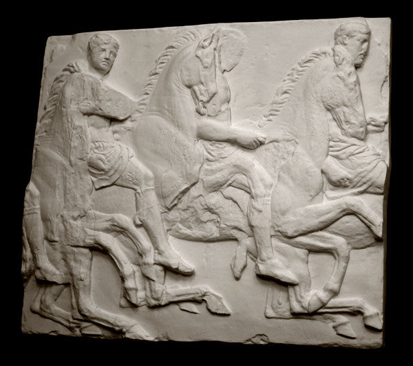 photo of off-white plaster cast relief sculpture of three men on horseback from Parthenon against black background