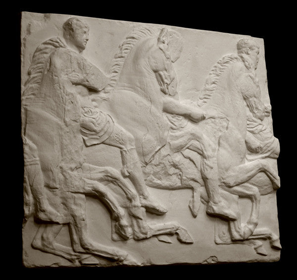 photo of off-white plaster cast relief sculpture of three men on horseback from Parthenon against black background