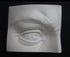 Photo of plaster cast sculpture of portion of face with right eye from Michelangelo's David statue on a black background