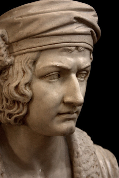 photo of plaster cast sculpture bust of man, namely Christopher Columbus, in robes and hat with black background