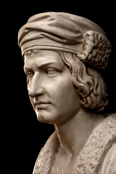 photo of plaster cast sculpture bust of man, namely Christopher Columbus, in robes and hat with black background
