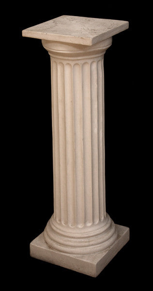 photo of white plaster cast pedestal in the Doric style with a fluted column against a black background