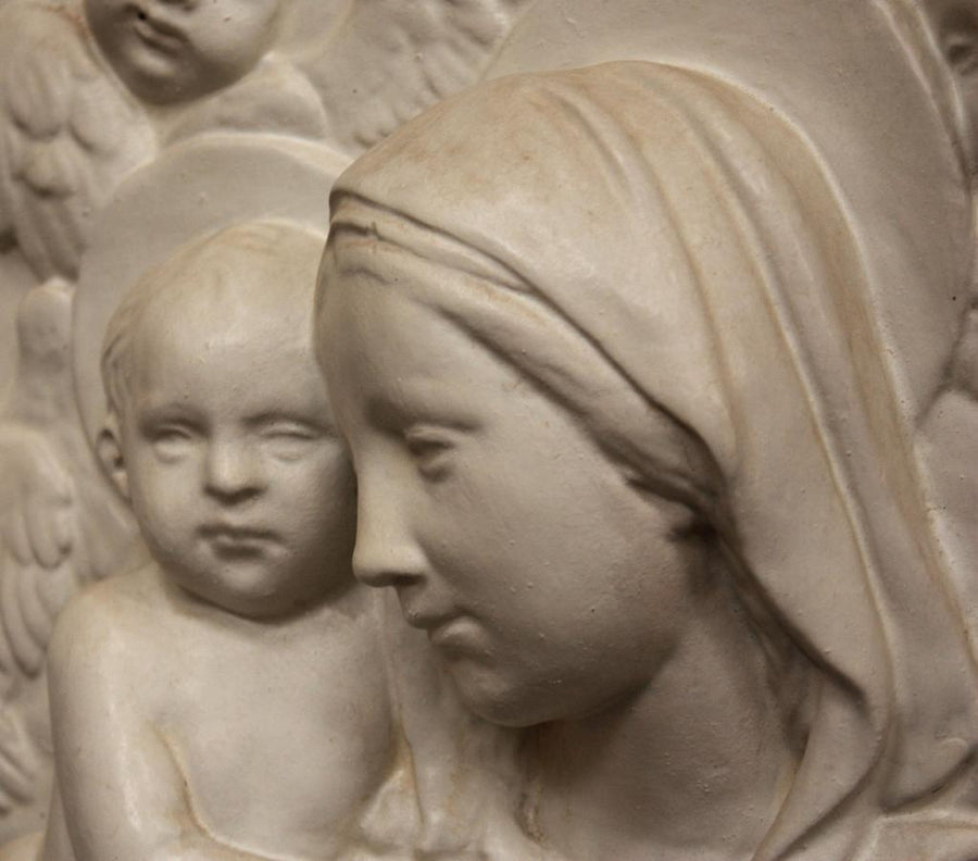 photo closeup of plaster cast relief of Madonna holding the Baby Jesus