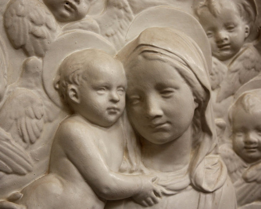 photo closeup of plaster cast relief of Madonna holding the Baby Jesus