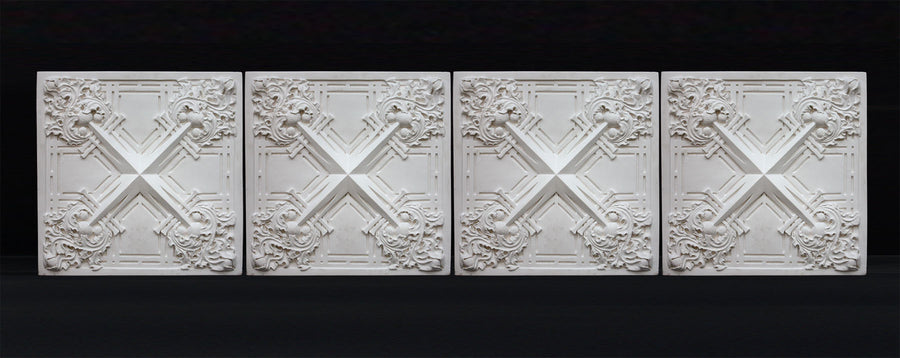 photo of white plaster casts of an architectural ornament with geometric lines and leaf patterns in a row against black background