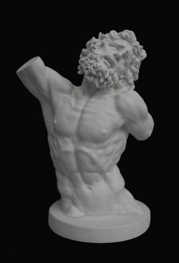 photo with black background of plaster cast sculpture of male torso and head with curly hair and beard, namely Laocoon