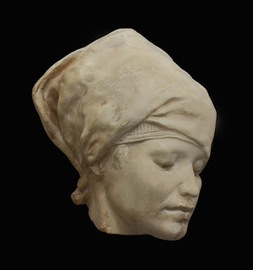 Photo of plaster cast of Nubian Female Mask on a black background