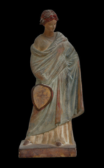 photo of plaster cast statue of female in green robes holding a fan at her side against black background